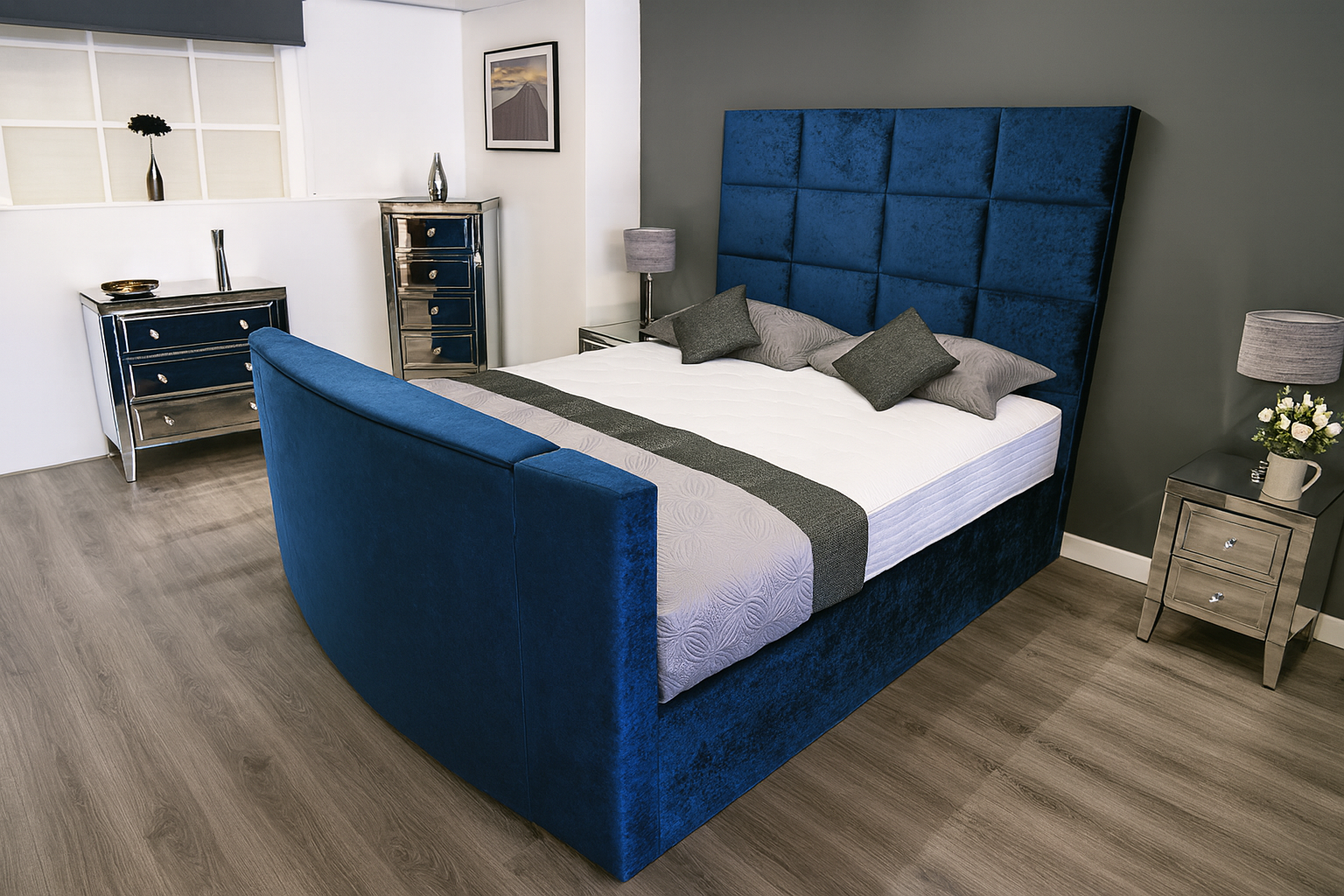 Modern bedroom with a blue upholstered bed and matching headboard.