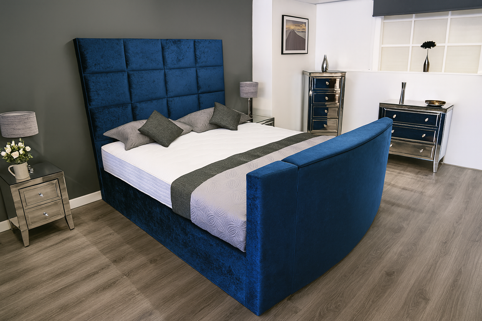 Modern bedroom with a blue upholstered bed and matching headboard.